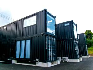 three black modular homes are parked in a parking lot at Villa Mikuri Tsunoshima - Vacation STAY 02206v in Shimonoseki