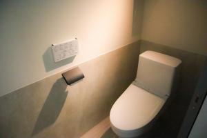 a bathroom with a toilet with a light on the wall at Villa Mikuri Tsunoshima - Vacation STAY 02206v in Shimonoseki