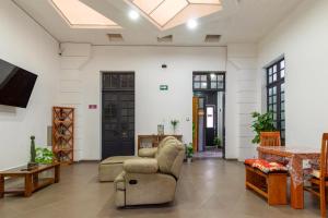 a living room with a couch and a table at Hostel Bemaro Mexico City in Mexico City