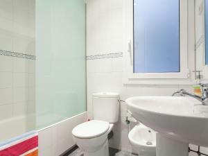 a white bathroom with a toilet and a sink at Apartment in Barcelona near Passeig de Gràcia in Barcelona +17 photos
