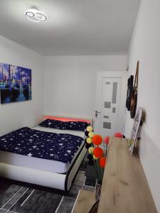 a bedroom with a bed and a wooden table at Perla Bocșei - Apartament Etaj 4 in Bocşa