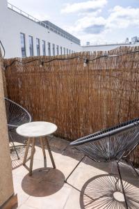a bench and a table and a chair on a patio at Loft Świetego Mikołaja - Blisko Rynku - Klimatyzacja in Wrocław +6 photos