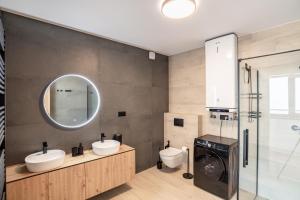 a bathroom with two sinks and a toilet and a mirror at Villa Cherry in Rogoznica +43 photos