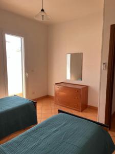 Postel nebo postele na pokoji v ubytování Casa vacanza relax a due passi dal mare