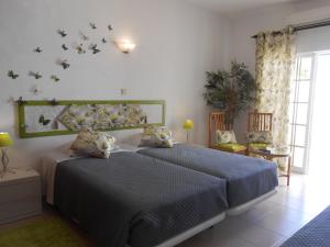 a bedroom with two beds and a window at Dona Ana Garden in Lagos