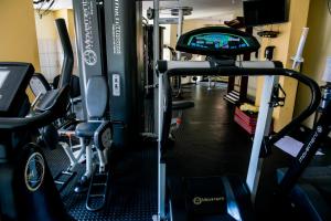 a gym with two tread machines and a tv at Apto com cozinha e lavanderia in Joinville