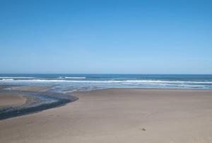 an empty beach with the ocean in the background at Oceanfront Suite - Upper Floor in Lincoln City