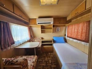 a small room with a bed and a table at Camping Little Oasis in Ezerets +56 photos