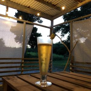 a glass of beer sitting on a wooden table at Komorebi - Vacation STAY 19098 in Kuroshima