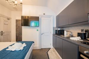a kitchen with a sink and a counter top at Modern Studio - Steps from Marina in Dublin