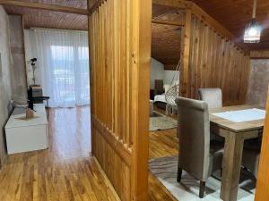 a dining room with a table and a living room at Apartman Vana in Vrnjačka Banja +12 photos