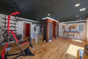 a room with a gym with a treadmill at Sleeps 29 Pool Tiki Bar Gym Hot Tub Dogs Welcome in Ooltewah
