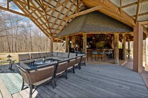 a pavilion with chairs and a bar on a deck at Sleeps 29 Pool Tiki Bar Gym Hot Tub Dogs Welcome in Ooltewah