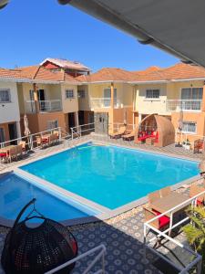 a swimming pool at a hotel with a resort at Hôtel Sofia Bellevue in Antsohihy +6 photos
