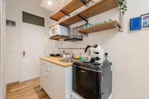 a small kitchen with a sink and a refrigerator at Bright Summer Studio Pool-Parking -30m dal Mare in Isola Bacucco