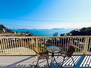 a table and chairs on a balcony with a view of the ocean at Ohana Inn - Vacation STAY 10994v in Kuka