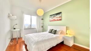 a bedroom with a white bed and a window at Edna 2 in Funchal