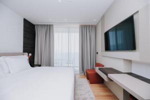 Voodi või voodid majutusasutuse Magnus Hotel toas