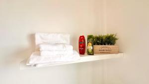 a white shelf with towels and a bottle of shampoo at Edna 2 in Funchal