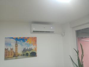 a picture on a wall with a picture of big ben at Apartman MD in Lukavica