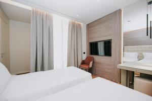 Voodi või voodid majutusasutuse Magnus Hotel toas