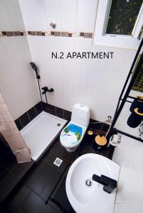 a bathroom with a white toilet and a sink at Thalassa Luxury Apartments - Korinos in Skála Korinoú +58 photos