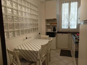 a kitchen with a table and chairs in a room at Mura di prati in Rome