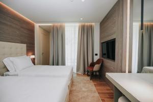 Voodi või voodid majutusasutuse Magnus Hotel toas