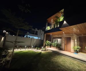 a house with a courtyard at night at Skywood Villa Rooms in Lucknow