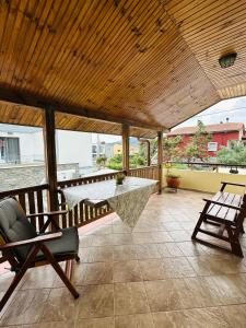 a patio with a table and chairs on a balcony at villa katerina in Iraklitsa +5 photos