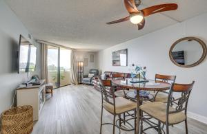 a dining room and living room with a table and chairs at Gulf-View Condo in Hudson Perfect for Snowbirds! in Hudson