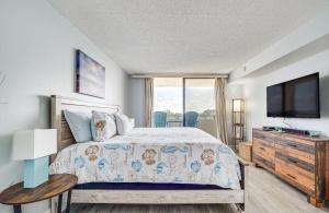 a bedroom with a bed and a flat screen tv at Gulf-View Condo in Hudson Perfect for Snowbirds! in Hudson +18 photos