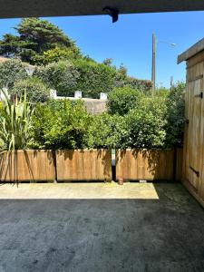 a wooden fence in front of a house at parlementia surf studio in Bidart
