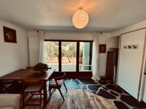 a living room with a table and a large window at parlementia surf studio in Bidart