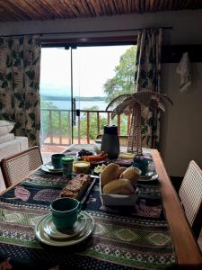 a table with food on it with a view of the ocean at Vila da Mata in Alter do Chao