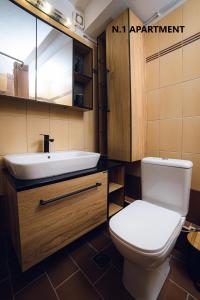a bathroom with a white toilet and a sink at Thalassa Luxury Apartments - Korinos in Skála Korinoú