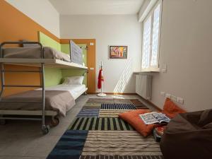 Postel nebo postele na pokoji v ubytování Casa Yaya Terrace & Design - Pesaro Centro Mare