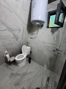 a bathroom with a toilet and a water tank at Villa Roi in Ferizaj +13 photos