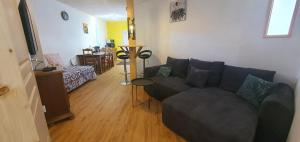 a living room with a couch and a table at Cramiland - Appart 02 Ohnenheim in Ohnenheim