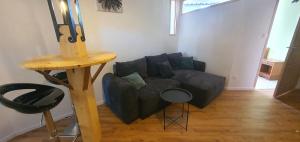 a living room with a couch and a table at Cramiland - Appart 02 Ohnenheim in Ohnenheim +11 photos