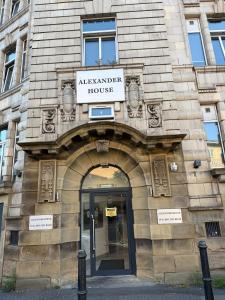 an entrance to a building with a sign on it at 1 Bedroom Lavish Studio Apartment in Bradford +7 photos