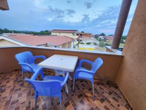 a table and chairs on a balcony with a view at Ajka apartments in Ulcinj
