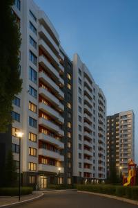 a large apartment building with windows at dusk at New Business-Class Apartment 1 хв від метро in Kyiv
