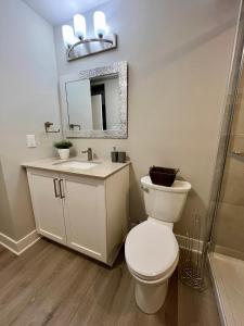 a bathroom with a toilet and a sink and a mirror at Medium Term Rental Close to Downtown Ottawa in Ottawa
