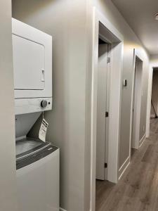a room with a kitchen with a microwave and a hallway at Medium Term Rental Close to Downtown Ottawa in Ottawa +4 photos