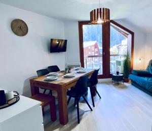 a dining room with a table and chairs in a room at 3 cows in Les Contamines-Montjoie