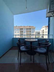 a table and chairs in a room with a balcony at D&M Apartments in Struga