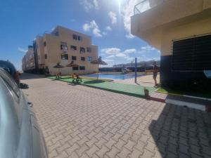 a building with a pool and a person standing next to a building at الشروق 2 résidence chourouk 2 in Mansouria +3 photos
