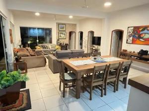 a kitchen and living room with a table and chairs at refugio buzios in Búzios