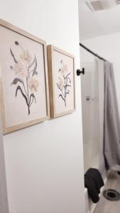 two framed drawings of flowers on a bathroom door at Grand Manor - Big 2 Bedroom - USA Side in Niagara Falls